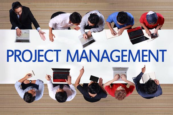 Project Management in business concept. Top view of businessmen meeting on working desk in office. Composite image, one person recomposed as many  - Photo, Image