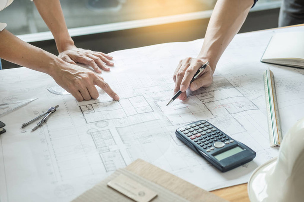professional architects working on blueprint discussing construction plans, engineer building, business co-working teamwork concept - Photo, Image