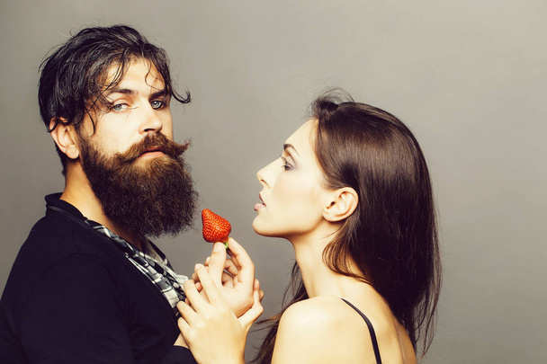 sexy couple eating red strawberry - Fotó, kép