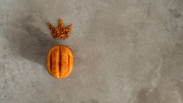 Top view of cookie in shape of walnut with crown made of crumbs on concrete background - Fotó, kép