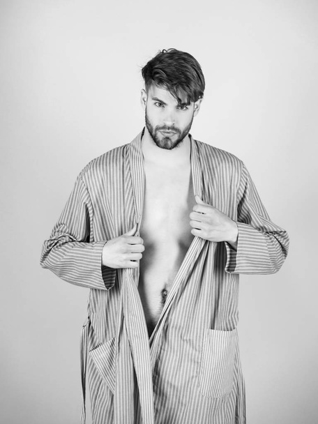 man undressing blue robe - Fotó, kép