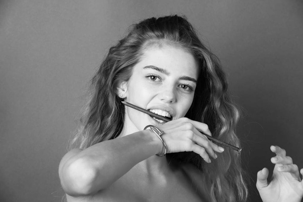 Sexy girl with metallic nail in mouth showing healthy teeth - Φωτογραφία, εικόνα