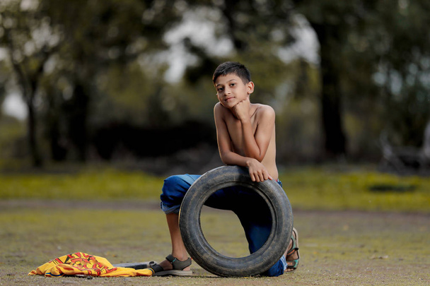Rural indian child playing at ground - Photo, Image