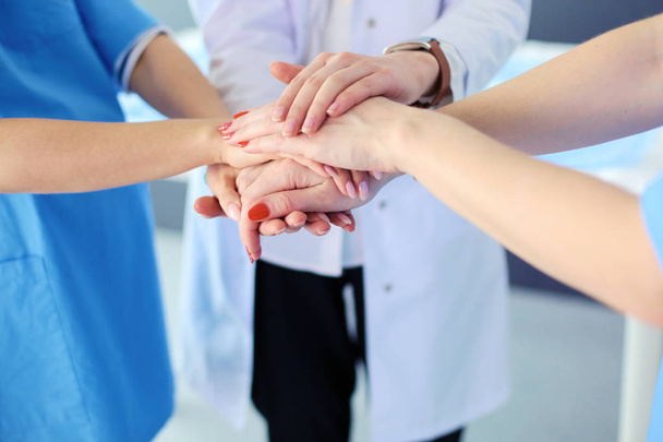 Doctors and nurses in a medical team stacking hands - Foto, Imagem