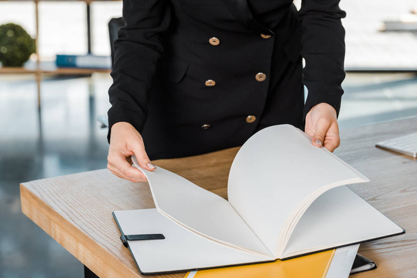 cropped image of businesswoman holding folder with documents in office - 写真・画像