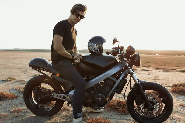 Nice man on  the motorcycle, in the middle of the desert, helmet, muscles, sun glasses, sand, tires, risky, free, outdoor, hairstyle, sport, relax, adventure, lifestyle, tires, chillout - Photo, Image