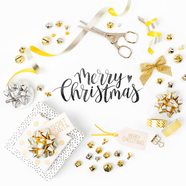 Christmas frame. Christmas decorations and gifts in gold colors on white background with empty copy space for text. Holiday and celebration. Flat lay, top view - Zdjęcie, obraz