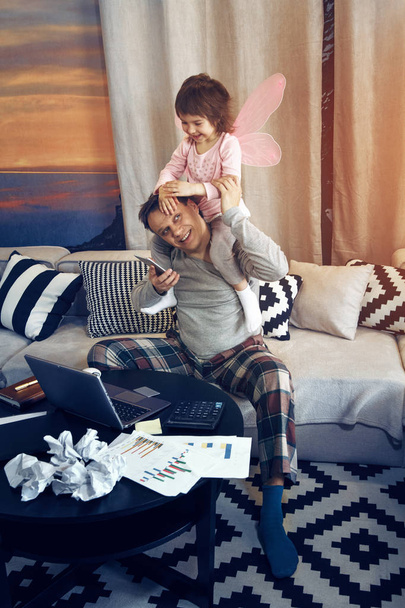 Father with his little daughter working at home - Фото, зображення