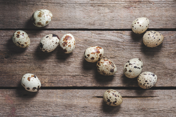 top view of fresh raw healthy quail eggs on rustic wooden table - 写真・画像