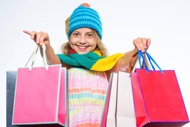 Shopping fall winter season. Shopping on black friday. Girl cute face wear knitted autumn hat and scarf hold shopping bags white background. Shopping concept. Fall season sales. Sale and discount - Fotó, kép