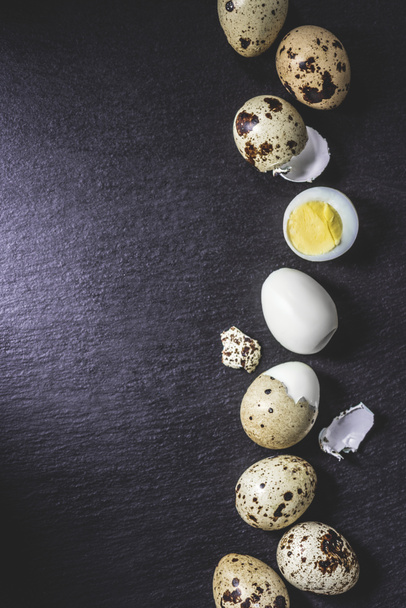 top view of healthy cooked quail eggs on black background  - Foto, imagen