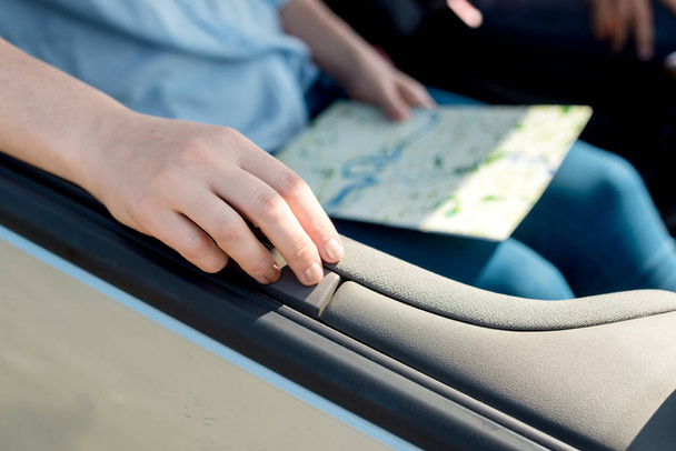 cropped shot of woman holding travel map inside car - Photo, Image