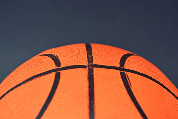 Κοντινό κομμάτι μπάλα μπάσκετ σε σκοτεινό φόντο - Φωτογραφία, εικόνα