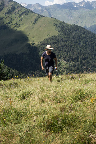 Lonely man practicing hiking in high mountains in summer. - Фото, зображення