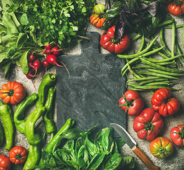 Healthy seasonal food cooking background. Fresh vegetables and greens over grey concrete background - Фото, зображення