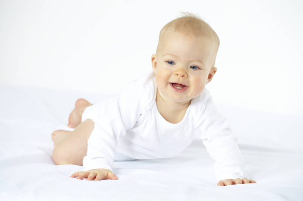 7 month old baby on white mattress, close-up  - 写真・画像