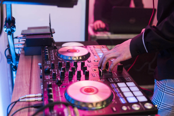 DJ reproduce y mezcla música en el controlador de mezclador digital. Controlador de rendimiento DJ de primer plano, sistema de mesa giratoria midi digital, par ajustable, plato giratorio de aluminio, fader, perilla y control deslizante, botón
. - Foto, Imagen