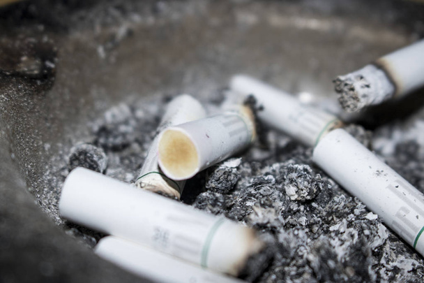 close up view of cigarette butts and ash as background - Photo, Image