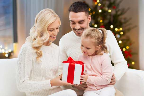 happy family at home with christmas gift - Zdjęcie, obraz