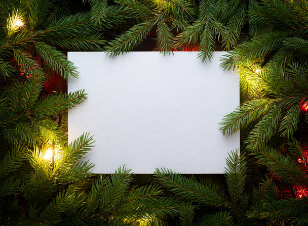 Christmas fir tree with garland. Flat lay, top view, copy space. Decorative frame of fir branches and paper card note - Photo, Image