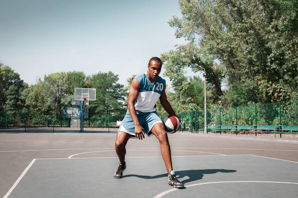 Picture of young confused african basketball player practicing - Zdjęcie, obraz