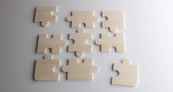 puzzles on a wooden background. Concept business. Idea: working in a team. Close up. - Photo, Image