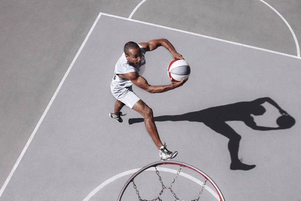 Picture of young confused african basketball player practicing - Foto, Imagem