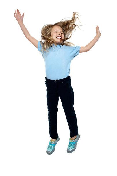 Delighted young girl jumping high in the air - Foto, Imagem