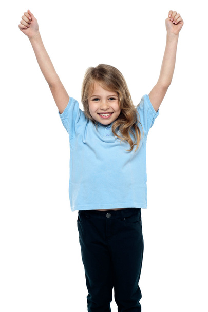Cute caucasian girl celebrating with raised arms - Foto, afbeelding