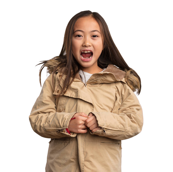 chinese little girl in beige jacket shouting isolated on white background - Фото, зображення