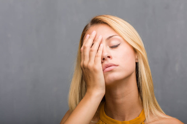 portrait of natural young blonde woman worried and overwhelmed - Photo, Image
