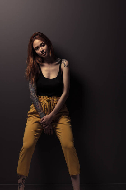 studio shot of pretty redhead girl on dark background  - Valokuva, kuva