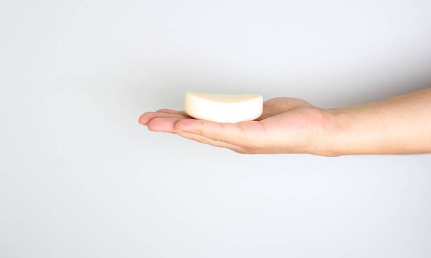 soap in a hand on a light background - Photo, image