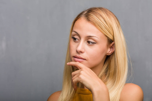 portrait of natural young blonde woman thinking and looking away - Photo, Image