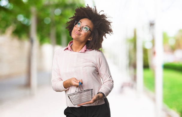 black woman holding shopping basket - Photo, Image