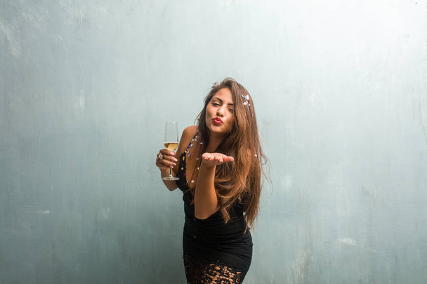 Young latin woman celebrating new year or event, holding champagne - Photo, Image