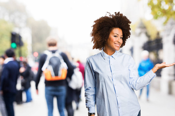 young black woman holding something on blurred background - Fotó, kép