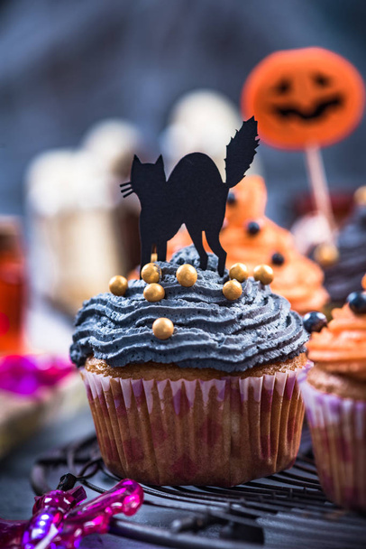 Black cupcake decorated for Halloween. - Фото, изображение