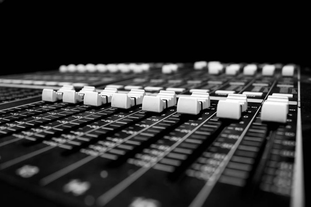 Wide angle closeup of Pro Audio Digital Mixing Console. White Faders and black control Console - Photo, Image