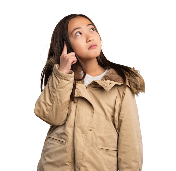 chinese little girl in beige jacket thinking isolated on white background - Foto, imagen