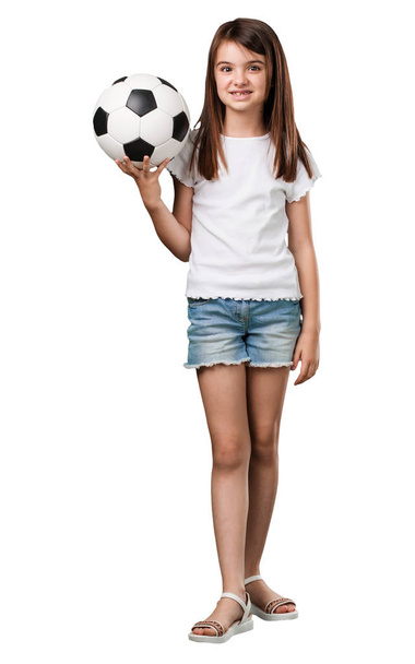 Full body little girl smiling and happy, holding a soccer ball, competitive attitude, excited to play a game - Φωτογραφία, εικόνα