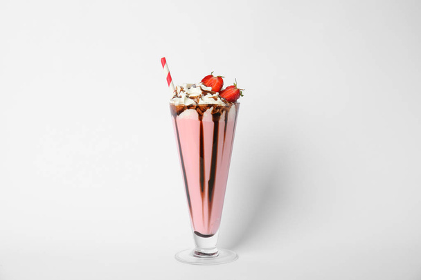 Glass of tasty milk shake on white background - Photo, Image