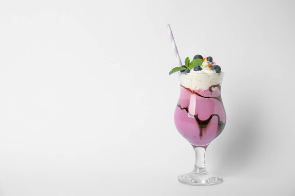 Glass of tasty milk shake on white background - Fotoğraf, Görsel