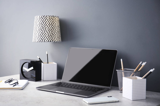 Modern munkahelyi laptop asztalra. Üres képernyő a makett - Fotó, kép