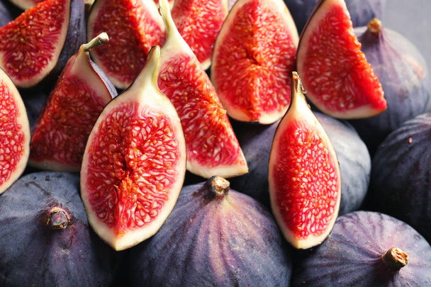 Fresh ripe fig slices as background. Tropical fruit - Photo, image