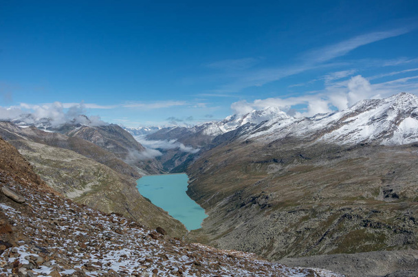 View to Stausee lake near Saas Fee in the southern Swiss Alps from Monte Moro pass, Italy - Photo, image