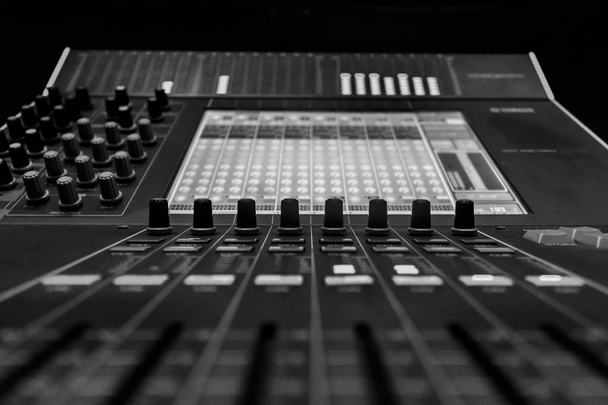 Closeup of Pro Audio Digital Mixing Console. Black control Console with digital dislpay in background - Photo, Image