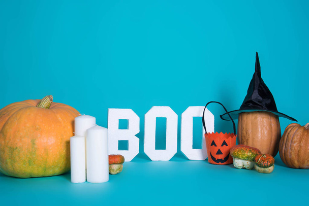 Halloween holiday background with pumpkins on blue background. View from above. - 写真・画像