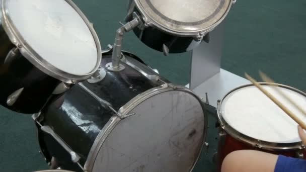 El adolescente está aprendiendo a tocar el tambor. Palos de tambor golpean diferentes tambores platillos
 - Metraje, vídeo