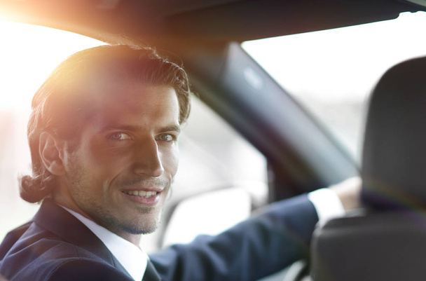 man sitting behind the wheel of a car - Фото, изображение